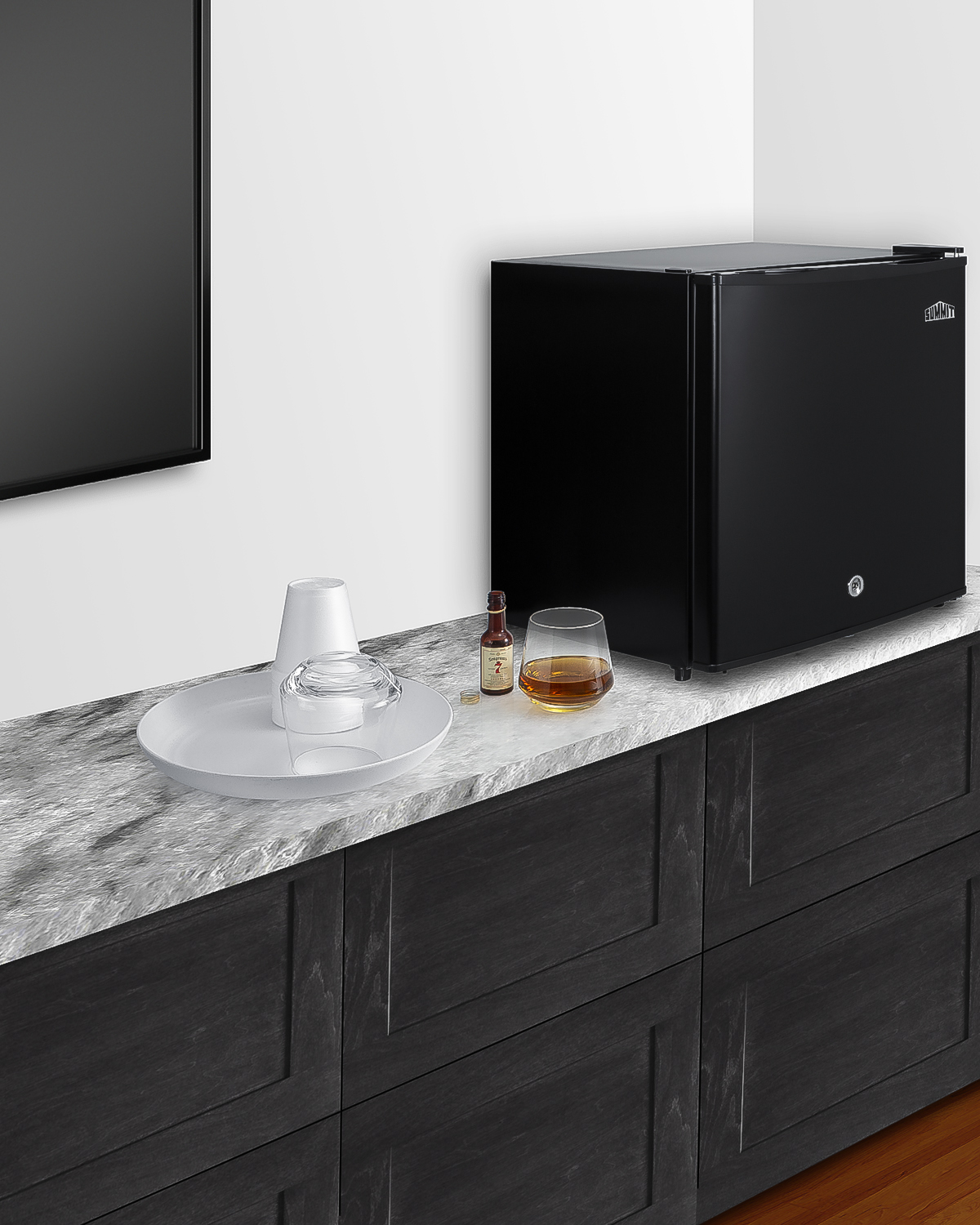Compact minibar with reversible door, front lock, and black exterior